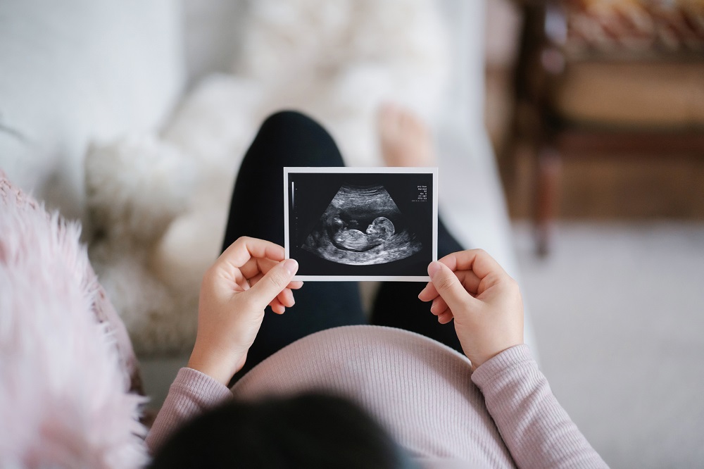 Pregnant woman looking at a sonogram. BCBSIL can help you navigate Special Enrollment after childbirth.