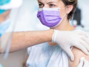 Woman in mask getting vaccine