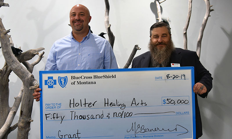 Blue Cross and Blue Shield of Montana’s Corey Palmer, left, presents the Holter Museum of Art's Chris Riccardo with a $50,000 Healthy Kids, Healthy Families grant Tuesday in Helena.