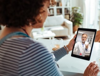 Woman and doctor video chat on tablet