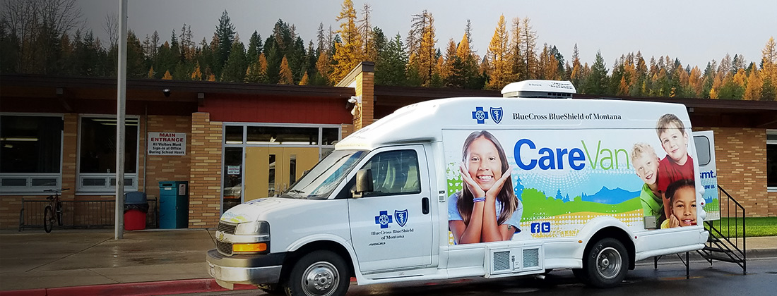 Care Van parked on pavement near community center.