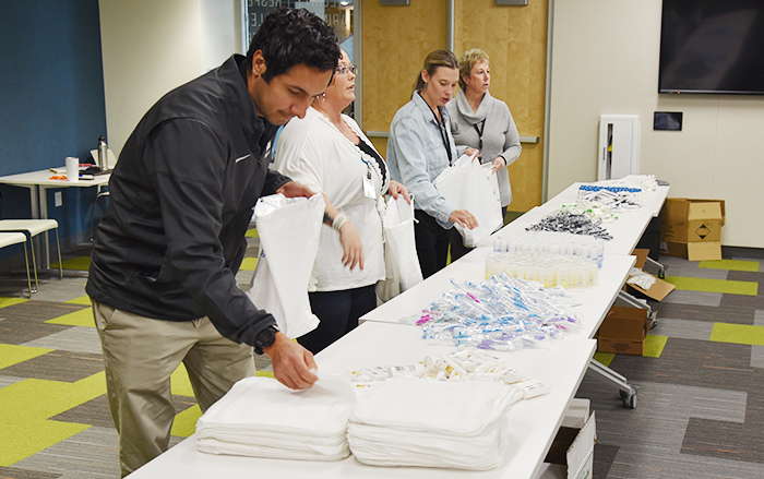 Volunteers fill care bags for community members.