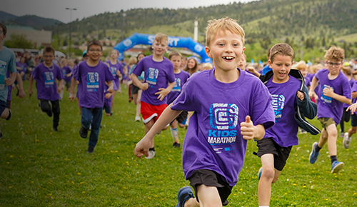 Kids run outdoors during community health marathon.