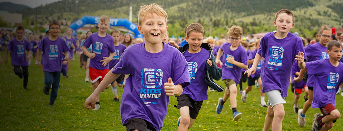 Kids run outdoors during community health marathon.