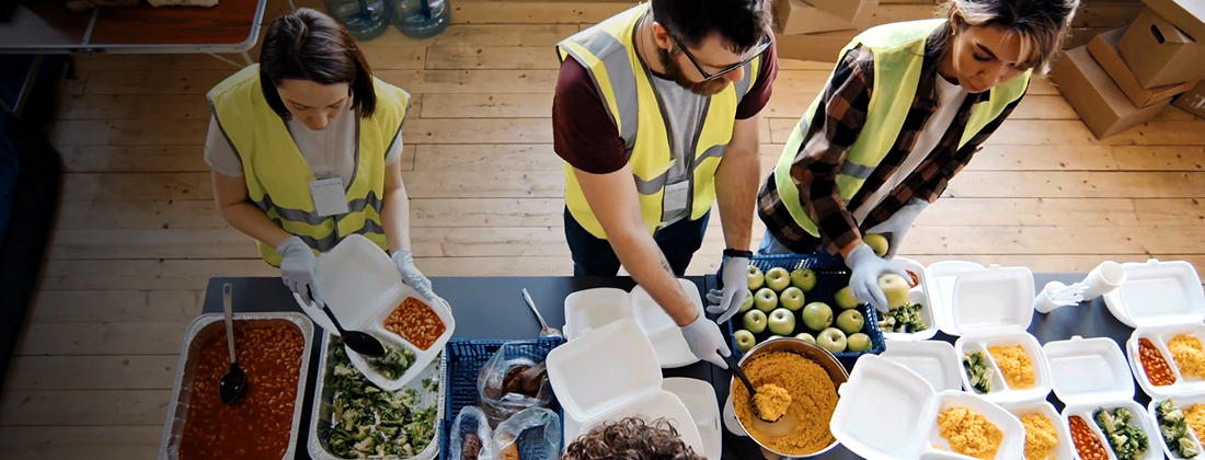 Food pantry workers giving out hot meals