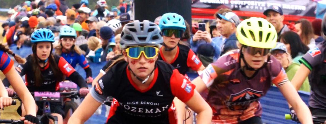 Crowd of youths on bikes riding in race