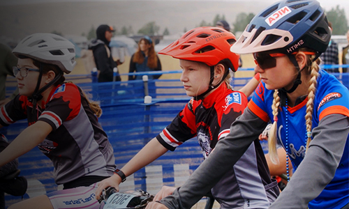 Three youth girls participating in a bike race