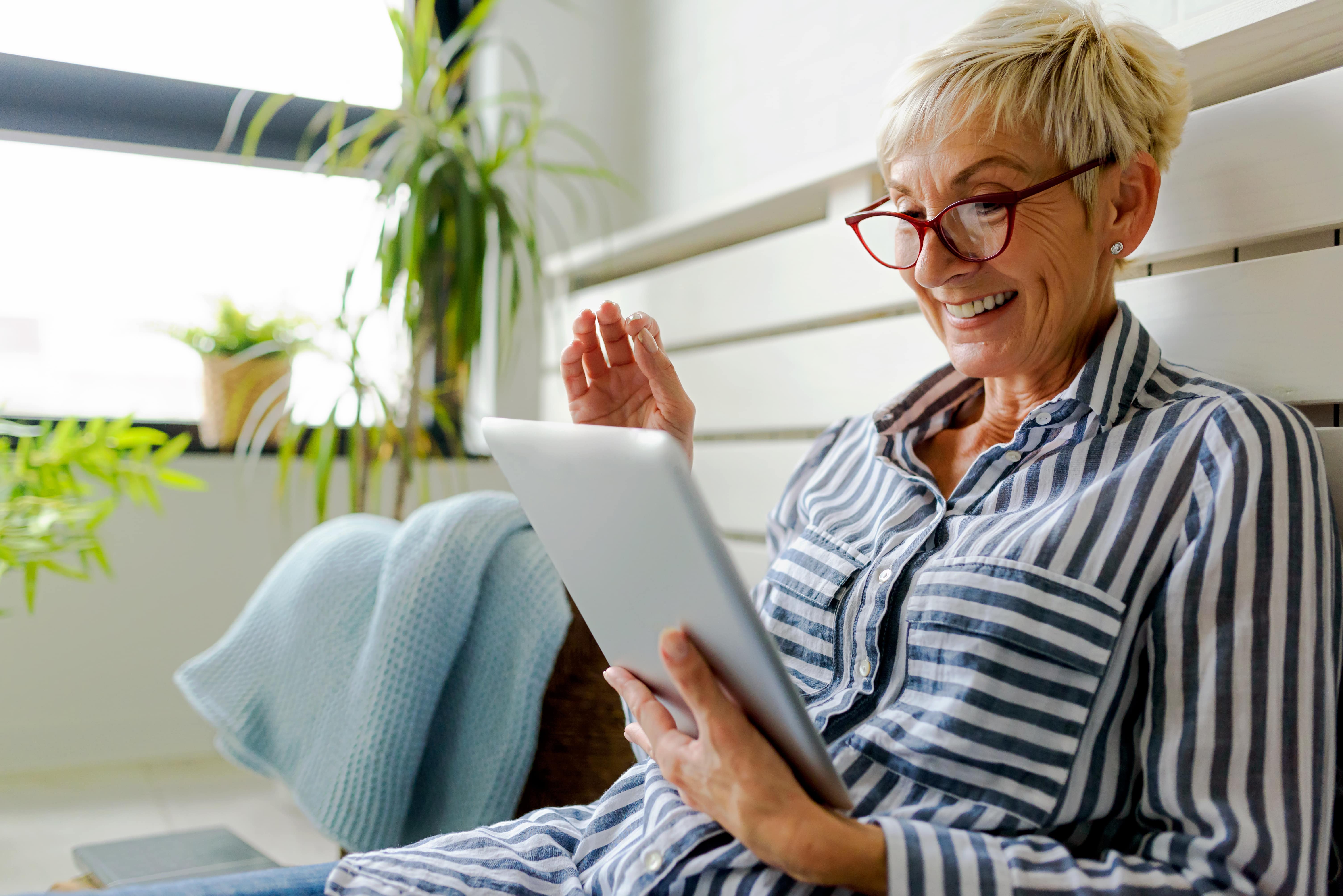 Woman smiling and holding a tablet