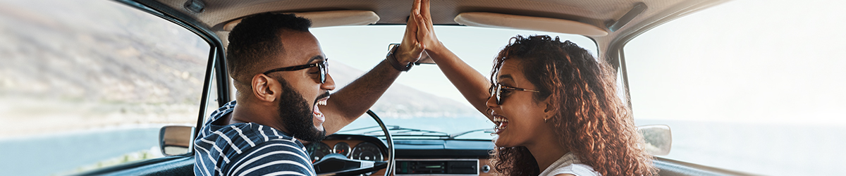Couple high-fiving in car