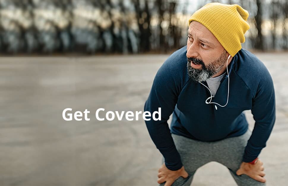Man wearing headphones and winter hat, jogging outside in the park